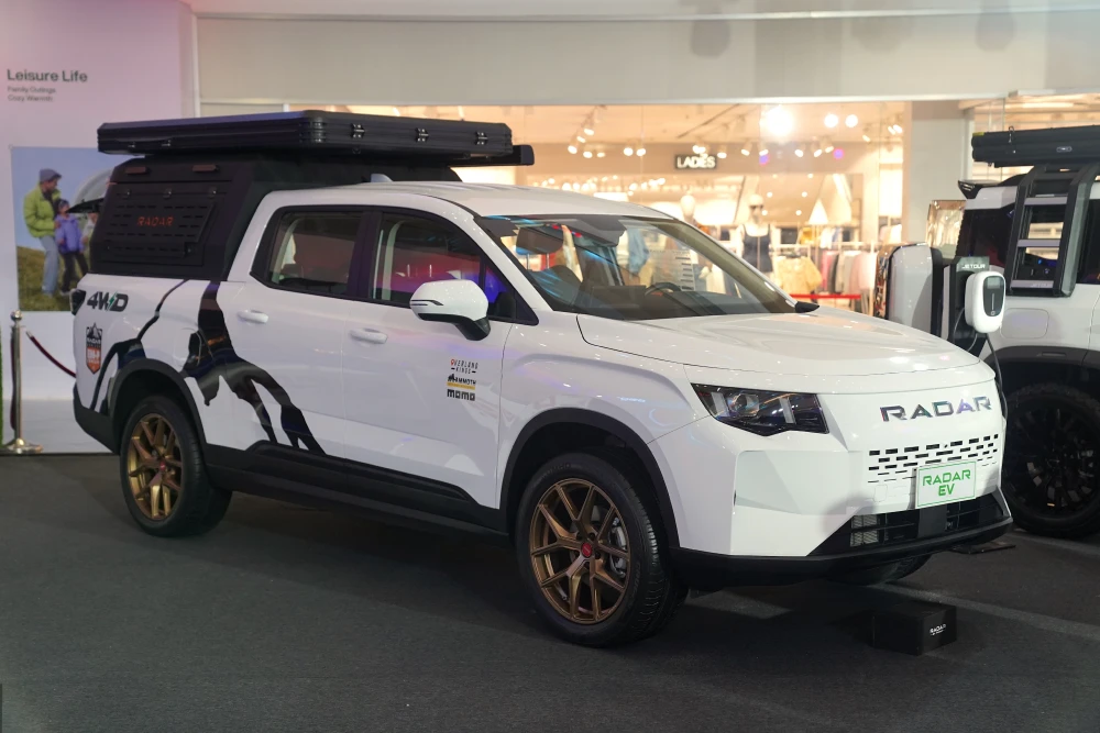 Adventure-ready RADAR RD6 EM-P Elite 4WD exhibiting its cutting-edge design with a roof tent and custom decals.