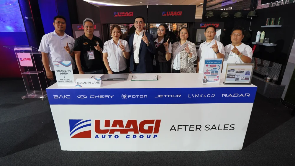 UAAGI Auto Group After Sales personnel at their event booth, committed to providing top-tier service.